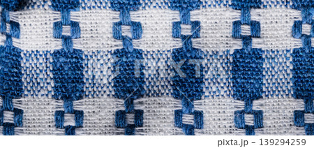 Traditional blue and white woven textile with geometric pattern for a handmade fabric background 139294259