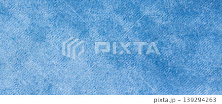 Light blue denim chambray fabric texture with fine woven surface as a background 139294263