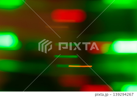 Abstract blurred green and red neon light bokeh on a dark background with glowing oval shapes 139294267