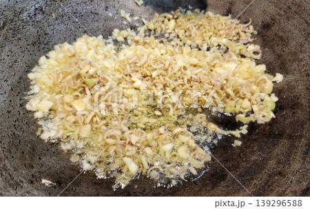 Sauteing Minced Garlic and Lemongrass in a Hot Wok for Asian Cooking Sauteing Minced Garlic and Lemongrass in a Hot Wok for Asian Cooking 139296588