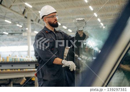 Many of the professional equipment and materials for windows making. Warehouse worker in an industrial environment of a factory or storage area Many of the professional equipment and materials for windows making. Warehouse worker in an industrial environment of a factory or storage area 139297381