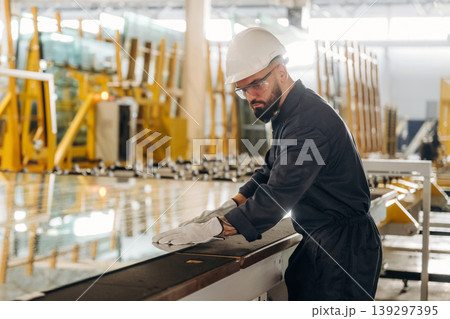 Crystal clear glass. Warehouse worker in an industrial environment of a factory or storage area Crystal clear glass. Warehouse worker in an industrial environment of a factory or storage area 139297395
