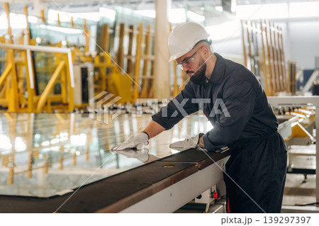 Crystal clear glass. Warehouse worker in an industrial environment of a factory or storage area 139297397