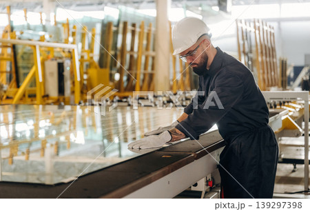 Crystal clear glass. Warehouse worker in an industrial environment of a factory or storage area Crystal clear glass. Warehouse worker in an industrial environment of a factory or storage area 139297398