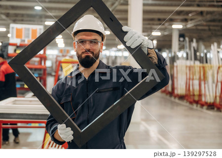 Border for small window, without glass. Warehouse worker in an industrial environment of a factory or storage area Border for small window, without glass. Warehouse worker in an industrial environment of a factory or storage area 139297528