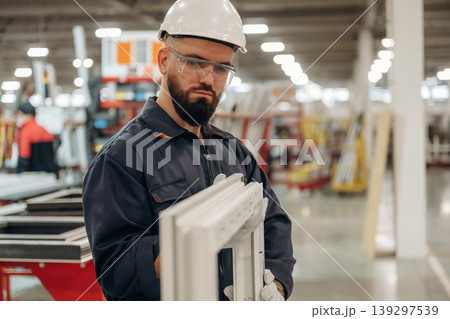 Warehouse worker in an industrial environment of a factory or storage area Warehouse worker in an industrial environment of a factory or storage area 139297539