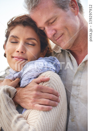 Couple, face and smile outdoor with hug for romance, love and relationship in nature with date or eyes closed. Mature, man and woman or embrace with happiness for bonding, honeymoon and support 139297912