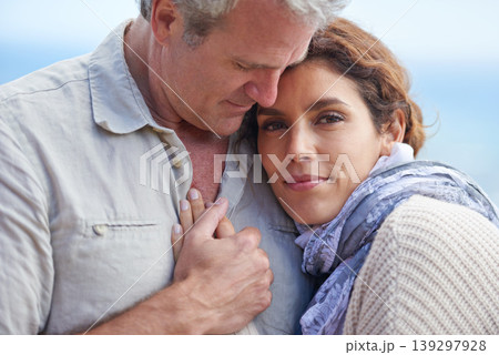 Couple, face and smile outdoor with hug for romance, love and relationship in nature with date. Mature, man and woman or embrace with happy, marriage and joy for bonding, honeymoon and support 139297928