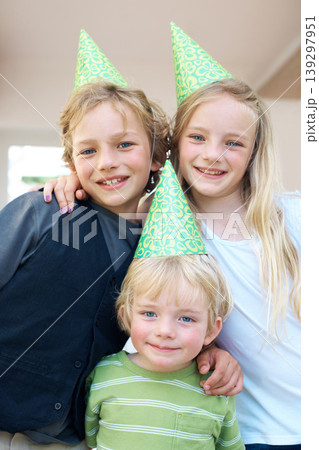 Family, children and portrait at birthday party, smile and celebration together in home. Happy kids, siblings and hat for event, face and bonding, care or support of brother, sister and girl in house Family, children and portrait at birthday party, smile and celebration together in home. Happy kids, siblings and hat for event, face and bonding, care or support of brother, sister and girl in house 139297951