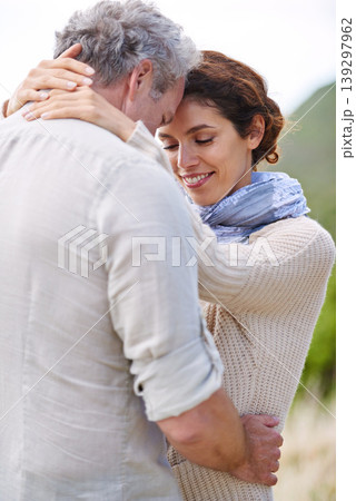 Couple, face and smile in nature with hug for romance, love and relationship outdoor with date. Mature, man and woman or embrace with happy, marriage and joyful for bonding, honeymoon and support Couple, face and smile in nature with hug for romance, love and relationship outdoor with date. Mature, man and woman or embrace with happy, marriage and joyful for bonding, honeymoon and support 139297962
