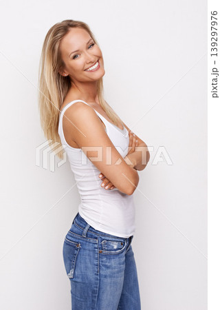 Happy, fashion and portrait of woman with crossed arms in studio for confidence, pride and attractive. Jeans, smile and isolated person in casual clothes, trendy outfit and style on white background 139297976