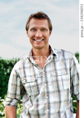 Man, portrait and happy outdoor in garden with confidence, casual style or trendy outfit and blue sky. Person, face and smile in backyard of home with pride, relax and peace on a weekend in nature 139298053
