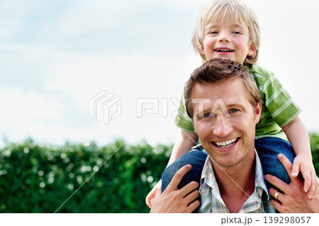 Father, son and portrait or smile with piggyback for bonding, relationship and freedom with blue sky in garden. Family, man and boy child with playing, care and love for excitement, peace and support Father, son and portrait or smile with piggyback for bonding, relationship and freedom with blue sky in garden. Family, man and boy child with playing, care and love for excitement, peace and support 139298057