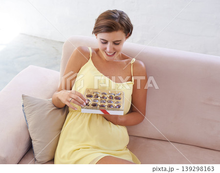 Pregnant woman, eating chocolate and happy in home, alone and enjoying delicious pregnancy craving. Good mood, comfort food and candy dessert for maternity, snack and sweet tooth satisfaction Pregnant woman, eating chocolate and happy in home, alone and enjoying delicious pregnancy craving. Good mood, comfort food and candy dessert for maternity, snack and sweet tooth satisfaction 139298163