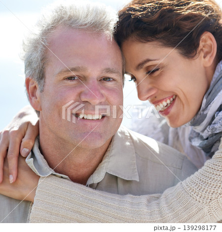 Couple, face and laughing in nature with hug for romance, love and relationship outdoor with relaxing. Mature, man and woman or embrace with happy, peace and trust for bonding, honeymoon and support 139298177