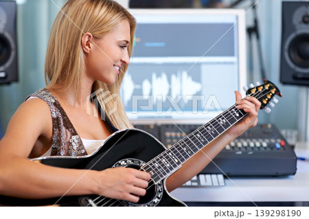 Woman, guitar and computer in recording studio for music with smile, ideas and creativity for art, album or song. Musician, artist and instrument with pc for sound, audio and happy for entertainment Woman, guitar and computer in recording studio for music with smile, ideas and creativity for art, album or song. Musician, artist and instrument with pc for sound, audio and happy for entertainment 139298190