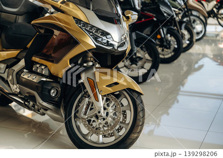 Motorcycles for sale are parked in a row indoors on the white tile Motorcycles for sale are parked in a row indoors on the white tile 139298206
