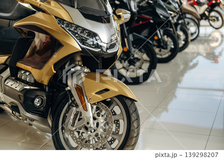 Motorcycles for sale are parked in a row indoors on the white tile Motorcycles for sale are parked in a row indoors on the white tile 139298207