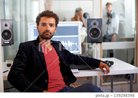 Portrait, media and a man producer in a recording studio mixing audio with a sound desk. Computer, tech or music with a serious young DJ or engineer creating a track for production or entertainment Portrait, media and a man producer in a recording studio mixing audio with a sound desk. Computer, tech or music with a serious young DJ or engineer creating a track for production or entertainment 139298398