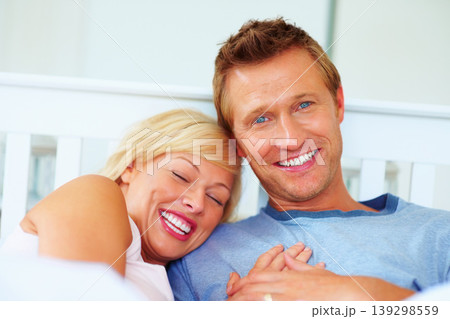 Couple, portrait and smile in bed of home for love, care and relax for holiday, break and support together. Man bond with woman in bedroom for happy relationship, freedom and romance in the morning Couple, portrait and smile in bed of home for love, care and relax for holiday, break and support together. Man bond with woman in bedroom for happy relationship, freedom and romance in the morning 139298559