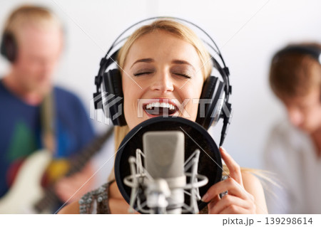 Happy woman, singer and microphone with headphones in music recording studio, sound track or podcast. Female person, blonde or musician smile on mic for audio listening, content creation and karaoke 139298614