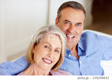 Smile, portrait or senior couple in home with love on sofa to bond or hug in a marriage commitment together. Happy, face or mature people in retirement with care or support in living room to relax Smile, portrait or senior couple in home with love on sofa to bond or hug in a marriage commitment together. Happy, face or mature people in retirement with care or support in living room to relax 139298632