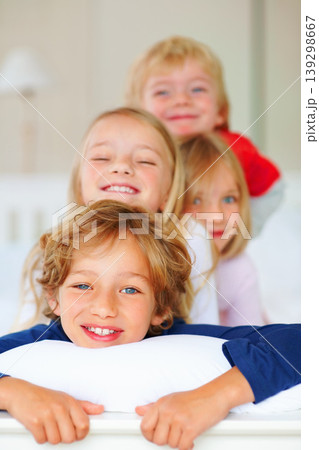 Portrait, smile or love with brother and sister sibling children on a bed in their home together. Family, happy or bonding with young boy and girl kids in the bedroom of an apartment on the weekend Portrait, smile or love with brother and sister sibling children on a bed in their home together. Family, happy or bonding with young boy and girl kids in the bedroom of an apartment on the weekend 139298667