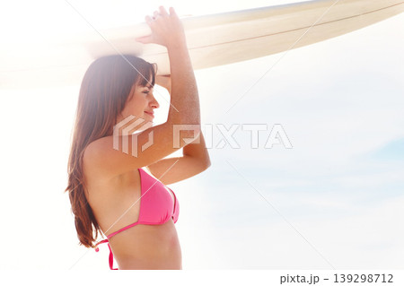Smile, surfboard and woman in bikini on beach for summer vacation, travel adventure and sunshine on tropical island. Surfing, blue sky and girl at ocean for happy holiday, sun and peace in Hawaii. Smile, surfboard and woman in bikini on beach for summer vacation, travel adventure and sunshine on tropical island. Surfing, blue sky and girl at ocean for happy holiday, sun and peace in Hawaii. 139298712