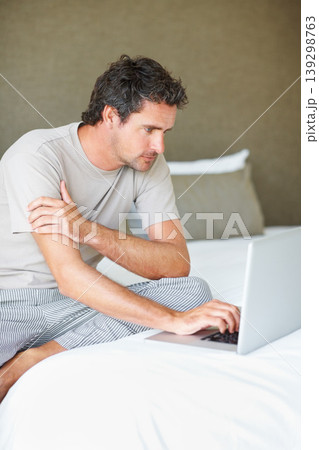 Freelancer, man in bedroom and laptop to work from home, smiling and sitting in bed for freelance job. Technology, Entrepreneur and remote worker for online job, company and marketing projects Freelancer, man in bedroom and laptop to work from home, smiling and sitting in bed for freelance job. Technology, Entrepreneur and remote worker for online job, company and marketing projects 139298763