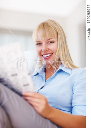 Businesswoman, portrait or newspaper on couch for reading headlines, media or happy in living room. Person, face or smile for morning relax wellness with magazine and current events for zen in home Businesswoman, portrait or newspaper on couch for reading headlines, media or happy in living room. Person, face or smile for morning relax wellness with magazine and current events for zen in home 139298935