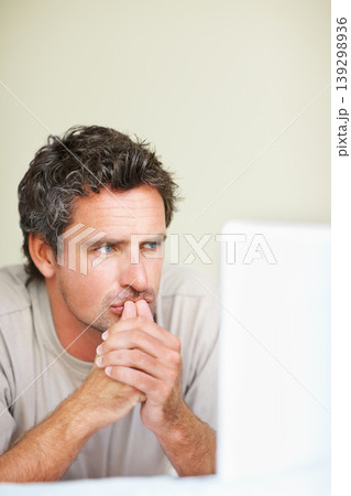 Thinking, man in house and laptop for work from home, serious and sitting alone for freelance job idea. Technology, entrepreneur and remote worker for online job, company and marketing projects 139298936