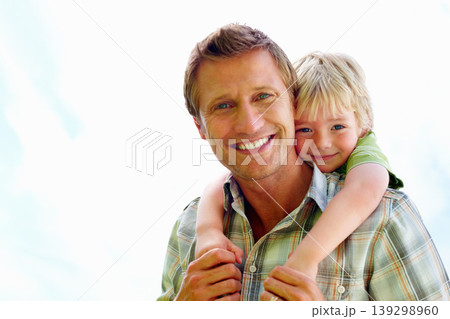 Father, son and portrait or happy with piggyback for bonding, relationship and freedom with sky in nature. Family, man and boy child with playing, care and love for excitement, mock up and support 139298960