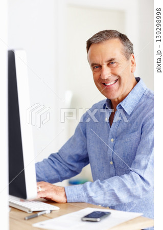 Mature man at desk with computer, portrait and happy networking on email, typing and planning budget. Smile, paperwork and senior businessman in office with invoice, bills and online business audit. 139298998