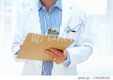 Hands, clipboard and man doctor a hospital for planning, schedule or surgery checklist closeup. Healthcare, compliance and male surgeon zoom with admin for insurance, documents or results analysis Hands, clipboard and man doctor a hospital for planning, schedule or surgery checklist closeup. Healthcare, compliance and male surgeon zoom with admin for insurance, documents or results analysis 139299102
