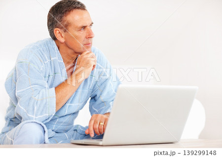 Thinking, morning and mature man on laptop for email, social media or streaming subscription on sofa. Internet search, couch and senior person on computer, website or networking ideas in living room. Thinking, morning and mature man on laptop for email, social media or streaming subscription on sofa. Internet search, couch and senior person on computer, website or networking ideas in living room. 139299148