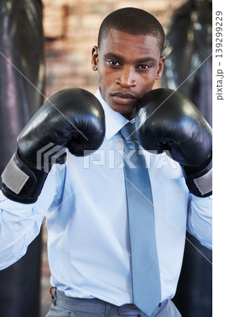 Man, portrait and boxing gloves in suit confident for manager job, ready for business or corporate competition. Black person, face and fighter gear for office achievement, career promotion at work 139299229