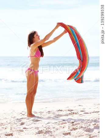 Woman, happy and towel on sand at beach for relax, sun tan and sunshine with bikini outdoor in summer. Person, smile and swimsuit by ocean with swimming, peace and wellness on holiday or vacation Woman, happy and towel on sand at beach for relax, sun tan and sunshine with bikini outdoor in summer. Person, smile and swimsuit by ocean with swimming, peace and wellness on holiday or vacation 139299338