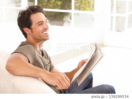 Man, reading and happy with newspaper on sofa for relax, morning break and information in living room. Person, face and smile for article, story and news on couch of apartment for headline or peace 139299534