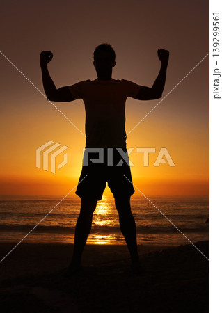 Silhouette, man and flex with sunset for winner, health and wellness on beach with sunrise and zen. Person, shadow and pilates or celebration for victory, mindfulness and healthy body by ocean or sea Silhouette, man and flex with sunset for winner, health and wellness on beach with sunrise and zen. Person, shadow and pilates or celebration for victory, mindfulness and healthy body by ocean or sea 139299561