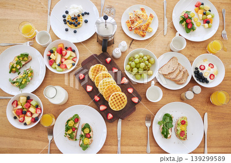 Table, breakfast and health with food, fruits and bread in home with plate, cutlery or salad. Above countertop, container or diet for nutrition with waffles, toast or juice for eating, drink and milk Table, breakfast and health with food, fruits and bread in home with plate, cutlery or salad. Above countertop, container or diet for nutrition with waffles, toast or juice for eating, drink and milk 139299589