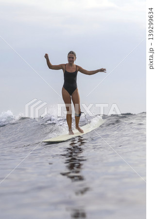Active Lifestyle Depicted Through Focused Surfing Balance Exercise In Daylight Active Lifestyle Depicted Through Focused Surfing Balance Exercise In Daylight 139299634