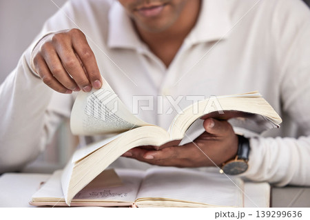 Hands, man and bible study at desk, home and reading for faith, knowledge and spiritual guide. Person, notebook and religion books on table for worship, peace and connection to holy spirit in house Hands, man and bible study at desk, home and reading for faith, knowledge and spiritual guide. Person, notebook and religion books on table for worship, peace and connection to holy spirit in house 139299636