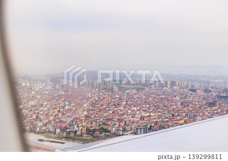 Aerial view of Istanbul city urban landscape with dense buildings through airplane window during flight 139299811