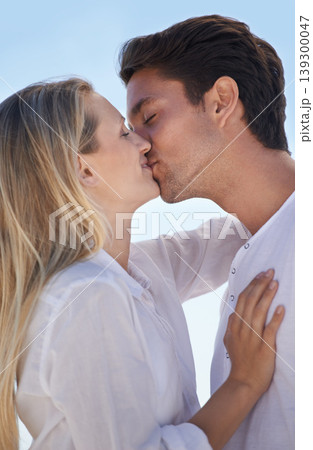 Love, care and couple kiss outdoor with support, trust and bonding, happy and sharing sweet relationship moment. Gratitude, respect and people embrace outside with freedom, vacation and romantic date 139300047