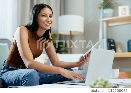 Tablet, laptop and portrait of woman on sofa and online for communication, website and remote work. Business, technology and person on computer for networking, social media and research at home Tablet, laptop and portrait of woman on sofa and online for communication, website and remote work. Business, technology and person on computer for networking, social media and research at home 139300055