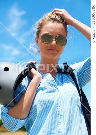 Safety, helmet and woman on blue sky for adventure, outdoor or portrait in countryside with confidence. Person, ready and start of skydiving, stunt or risk danger with hardhat protection for security 139300206
