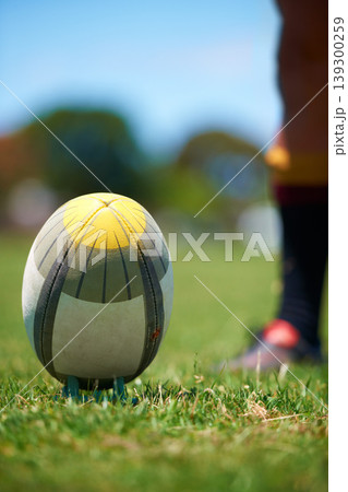 Closeup, rugby and leg with a ball of a player to kick for fitness training on a grass field. Man, uniform and sports exercise for healthy green lawn and active athlete playing for health Closeup, rugby and leg with a ball of a player to kick for fitness training on a grass field. Man, uniform and sports exercise for healthy green lawn and active athlete playing for health 139300259