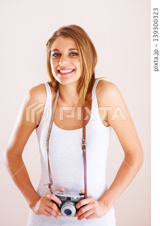 Smile, portrait and woman with camera in studio for photography, memory or nature on white background. Face, happy and female photographer with equipment for creative hobby, career or shooting 139300323