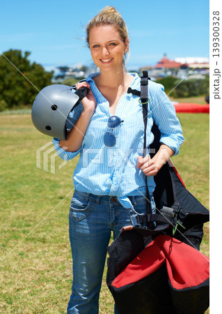 Skydiving, portrait and woman outdoor for adventure with gear and helmet in countryside with a smile. Happy, person and skydiver ready to start, stunt or risk danger with equipment for security Skydiving, portrait and woman outdoor for adventure with gear and helmet in countryside with a smile. Happy, person and skydiver ready to start, stunt or risk danger with equipment for security 139300328
