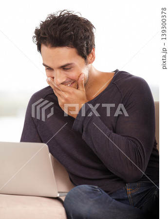 Laugh, laptop and online with man on sofa for funny social media, networking and connection. Website, streaming and digital with person in living room at home for relax, research and technology Laugh, laptop and online with man on sofa for funny social media, networking and connection. Website, streaming and digital with person in living room at home for relax, research and technology 139300378